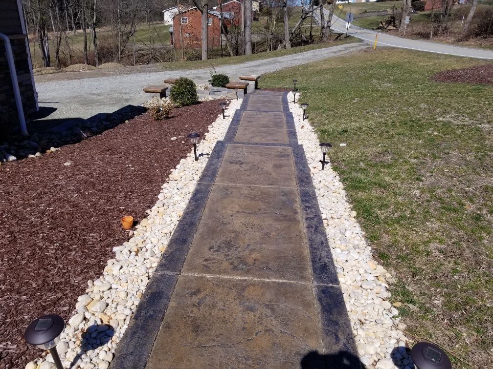 Concrete walkway with landscaping