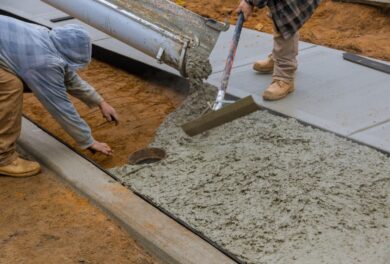 Crew members involved in Concrete Construction, shaping a new concrete pathway.