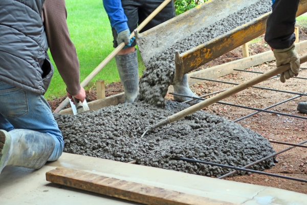 Pouring concrete to a commercial construction project.