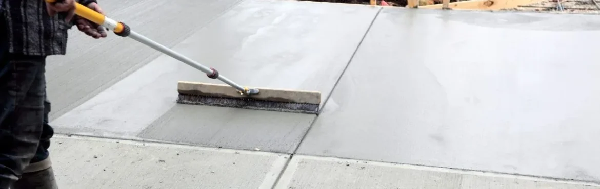 Construction company finishing a concrete driveway.