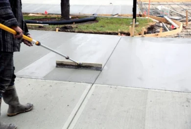 Construction company finishing a concrete driveway.
