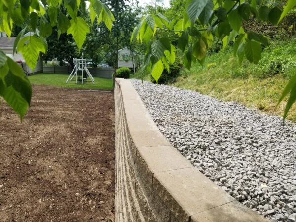 Backyard retaining wall built with reinforced soil system.