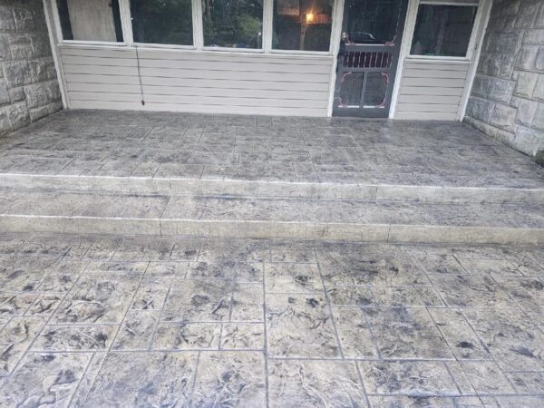 Backyard stamped concrete flooring with decorative texture.