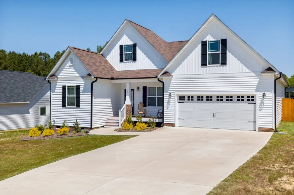 A well-maintained concrete driveway in front of a home