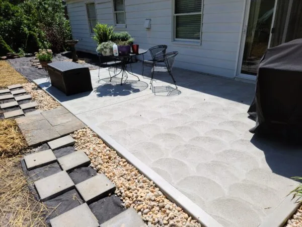 Spacious backyard patio with outdoor furniture.