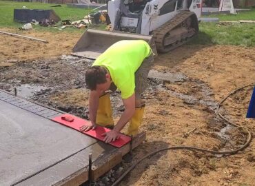 a man fixing the concrete floor